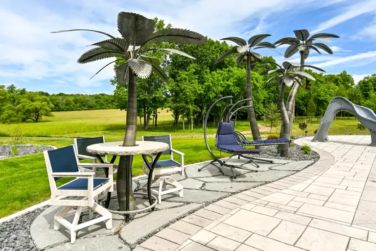 Signature metal palms beside a poolside patio